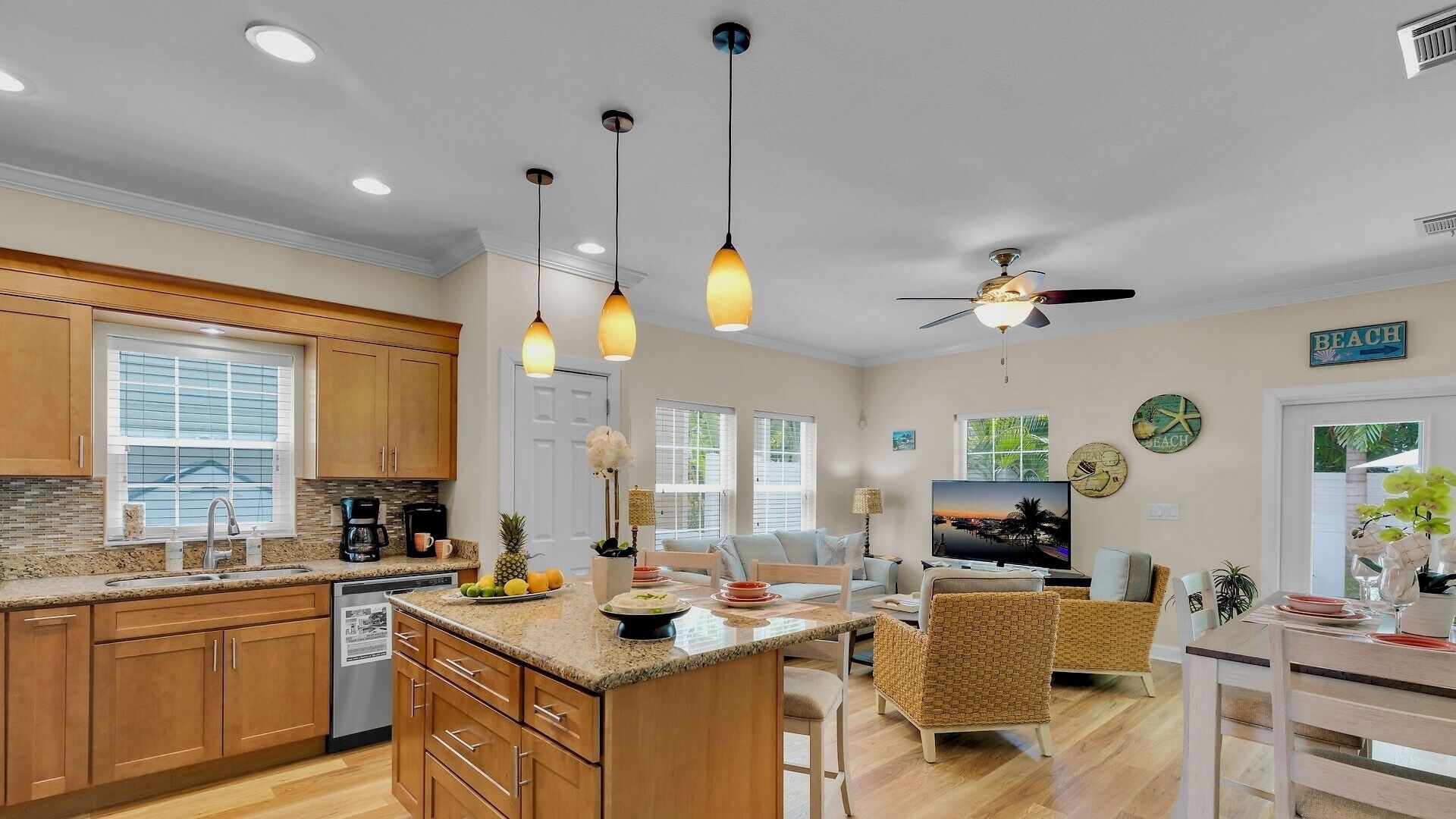 A spacious kitchen with granite countertops, wooden cabinets, and a central island.