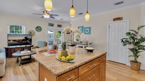 A kitchen with a granite countertop, wooden cabinets, a ceiling fan, and pendant lights. - **CAYO CALYPSO @ HIGGS BEACH** Home / Pool + Last Key White Glove Service... (Key West)