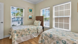 A bedroom with two beds, a window with blinds, and a door. - **CAYO CALYPSO @ HIGGS BEACH** Home / Pool + Last Key White Glove Service... (Key West)