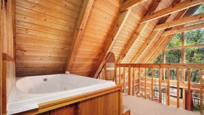 A wooden cabin with a hot tub, wooden beams, and large windows. - 3 king bedrooms with hot tub, pool table, arcade game, great location! (Sevierville)