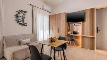 Superior Studio With Two Balconies | Living room | 43-inch Smart TV with cable channels