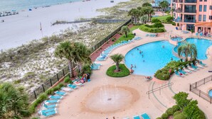 A resort with a large swimming pool, beach access, and a building with balconies. - Stunning Gulf Front Views! Sensational Amenities! (Orange Beach)
