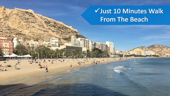 A beach with buildings in the background.