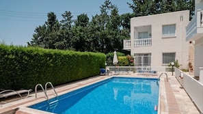 Outdoor pool, a natural pool, pool umbrellas, pool loungers