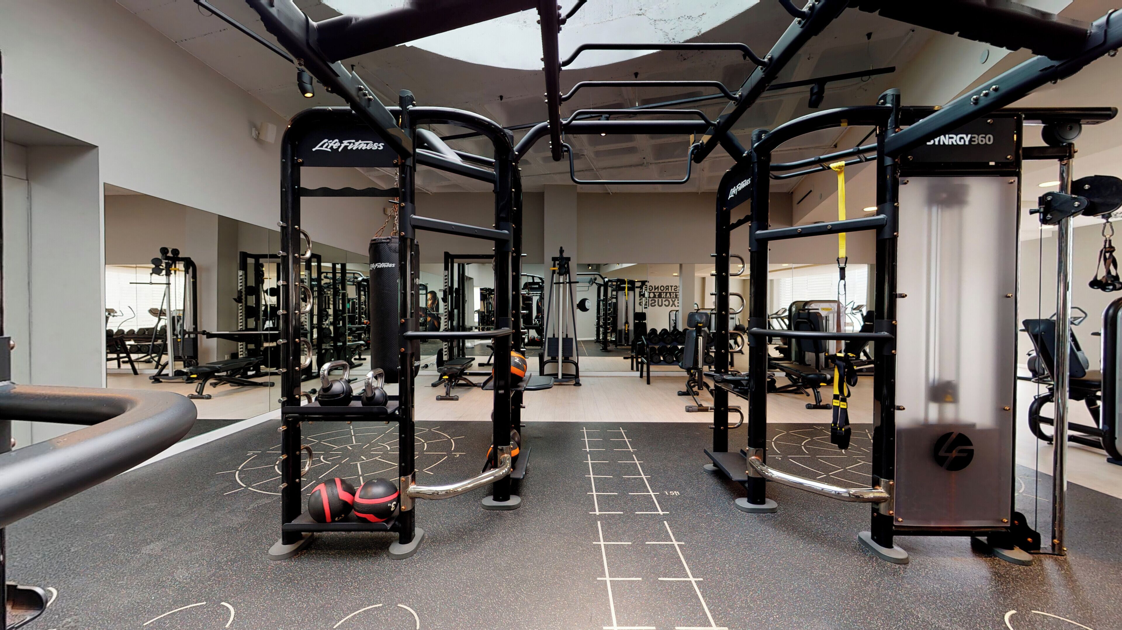 A gym with weightlifting equipment, treadmills, and exercise machines.