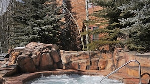 A hot tub surrounded by rocky terrain and trees. - Modern Ground Floor Unit/1 Minute Walk to the Gondola/Great Amenities (Keystone)
