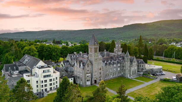 A large, historic building with multiple towers and a central courtyard. - The Highland Club (Fort Augustus)