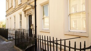 A building with a black iron fence, a white door, and a window with a white frame. - Gorgeous, peaceful & very central apartment with fabulous views. (Bath)