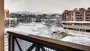 A snowy landscape with buildings and a river.
