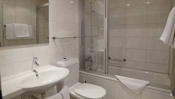 A modern bathroom with a sink, toilet, and shower.