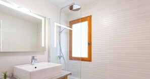 A modern bathroom with a white sink, a glass shower enclosure, and a wooden door. - Stunning panoramic view, Cham centre, Pkg & WIFI (Chamonix-Mont-Blanc)