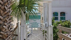 A gated entrance with a sign indicating private access for owners and guests only, with a warning against trespassing. - Great Location- Heart of Miramar Beach! So Close to Pool, Beach, & More! (Miramar Beach)