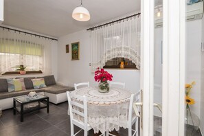 Relax in this inviting living room with a round table, comfortable sofa, and elegant coffee table.