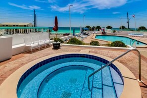 A rooftop pool with a view of the ocean, lounge chairs, and umbrellas. - Free Beach SRVC & Free Beach Bonfires M/F nts! Renovated! Fab Views &Amenities (Miramar Beach)