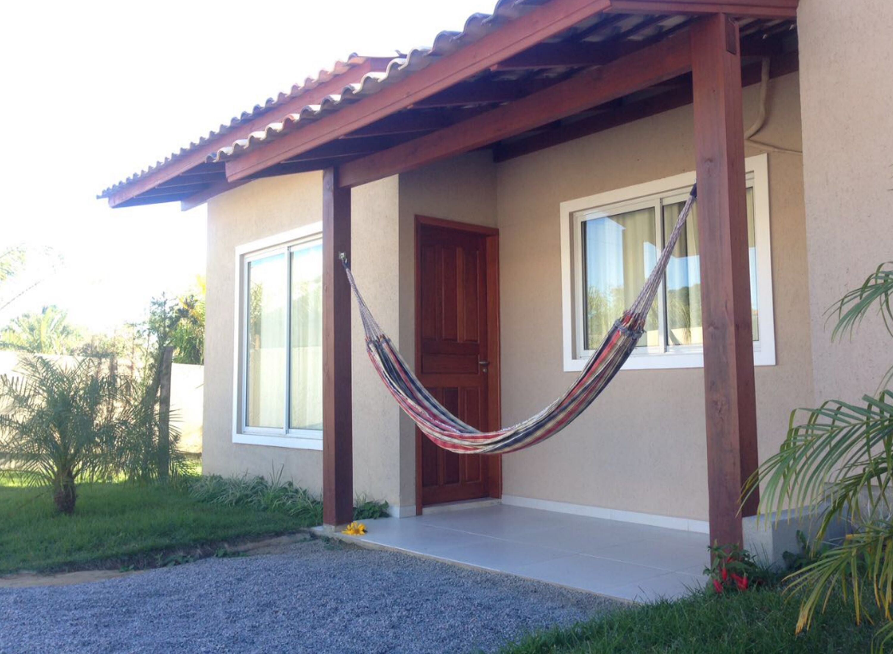 A house with a porch, a hammock, and a door.