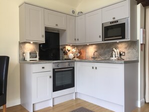 Well equipped kitchen with hob, oven, fridge, microwave, all crockery etc