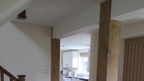 A kitchen with white cabinets, a microwave, and a washing machine.