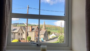 Una ventana con vistas a un pueblo, con edificios e iglesia.