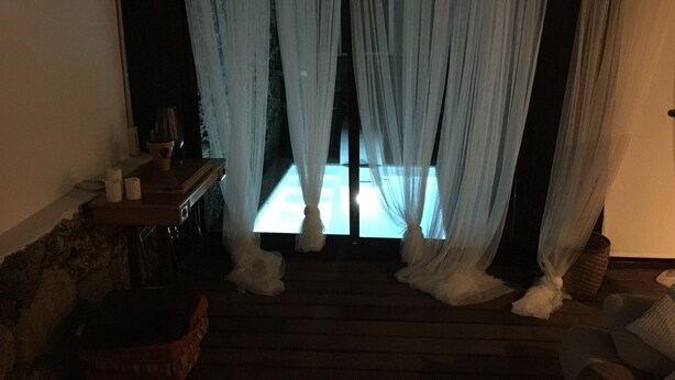 A room with a bed, a nightstand, and a window with sheer curtains. - CORRALEJO-Villa Tranquila with private pool (La Oliva)