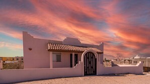 A single-story building with a flat roof, a tiled entrance, and a small window. - Cypress House close distance to the beach at Las Conchas (Puerto Peñasco)