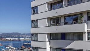 Ein mehrstöckiges Gebäude mit Balkonen mit Blick auf eine Marina.