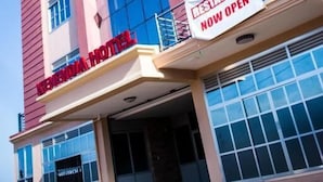 A hotel with a prominent sign indicating a restaurant is now open. - Kenendia Hotel (Kampala)