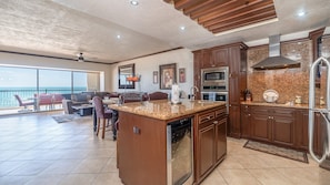 Enjoy cooking in the well-equipped kitchen with a central island, microwave, oven, and dishwasher.