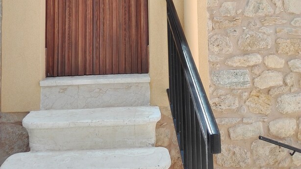 A wooden door with a metal gate, a stone wall, and a number '38' sign. - Anita's House in the Heart of Segesta CIN IT081003C2BTVOXQJS  (Calatafimi)