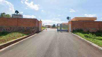 A road leading to a gated entrance with a sign reading "CENETRA."