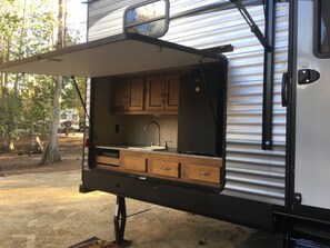 Fridge, microwave, coffee/tea maker, cookware/dishes/utensils
