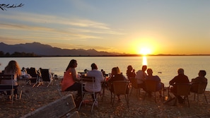 Guests can enjoy serene lakeside views from comfortable outdoor seating.