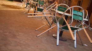 Rows of green Heineken-branded bar stools with metal frames and green cushioned seats, arranged in a line on a patterned floor. - Owee's Place (Lagos)