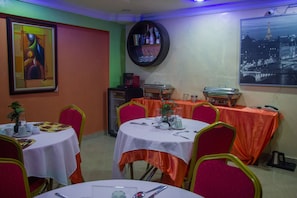 A dining area with round tables, chairs, and a buffet setup. - Bravehearts Courts (Lagos)