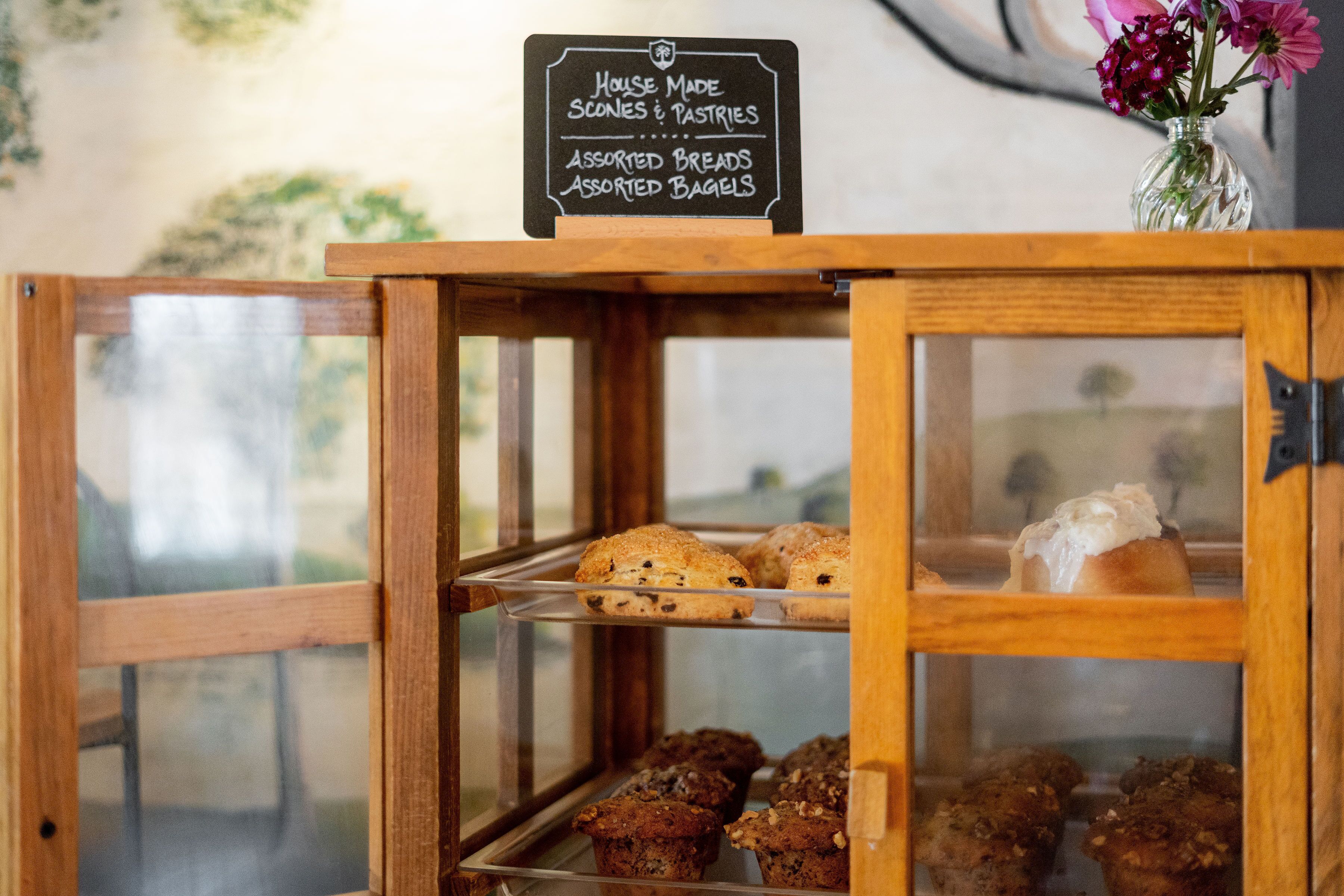 A bakery display case with assorted breads and pastries.