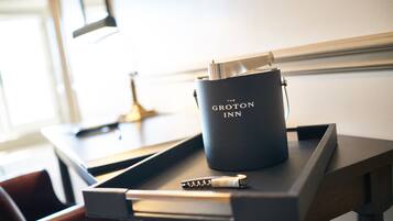 A black tray with a black mug labeled "The Groton Inn" and a pen on it.