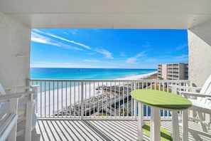 Ein Balkon mit Blick auf Strand und Meer.