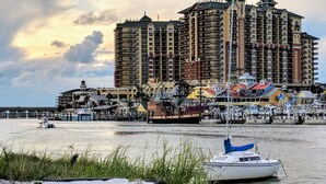 A coastal hotel with multiple floors, a pier, and boats. - 622- Set your clock to Beach time! Renovated, high end Condo, stunning views (Destin)