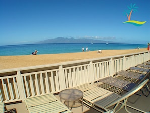 Relax in a beachside haven with ocean views and a distant mountain range.