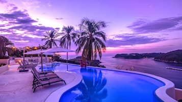 An infinity pool, sun loungers