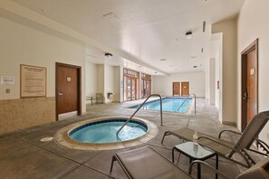 A hotel lobby with a swimming pool, a hot tub, and lounge chairs. - Cozy Mountain Condo/Pool and Hot Tub Access/Stunning Views (Keystone)