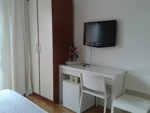 Desk, iron/ironing board, bed sheets