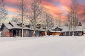 A row of houses with snow-covered roofs and a clear sky.