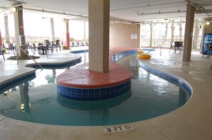 An indoor swimming pool with a 3 FT depth marker, lounge chairs, and a no lifeguard on duty sign. - Spacious oceanfront, corner unit + Free Attraction Tickets! (North Myrtle Beach)