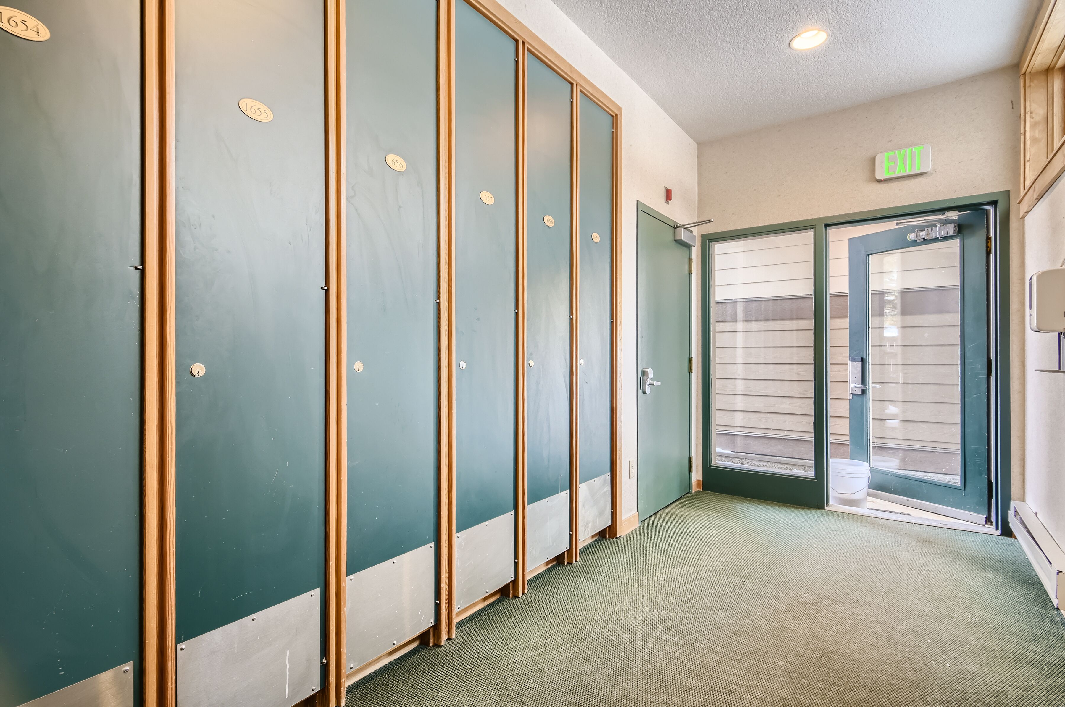 A hallway with multiple doors, each marked with a number.