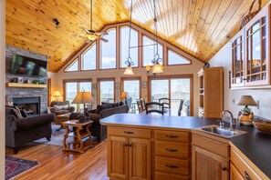 A spacious living area with a fireplace, a large television, and a cozy seating arrangement.
