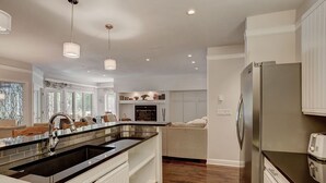 A modern kitchen with a large island, stainless steel appliances, and pendant lighting. - Stunning Ski-In Ski-Out Condo/Private Hot Tub/Recently Updated (Dillon)