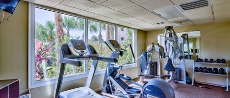 A gym with treadmills, an elliptical, and free weights.