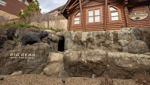 A log cabin-style building with a sign reading "Big Bear Lodge & Resort."