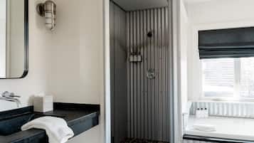 Bathtub, hair dryer, bathrobes, towels