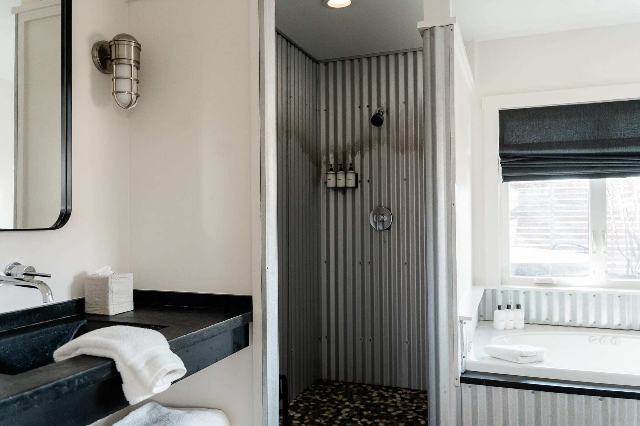 Bathtub, hair dryer, bathrobes, towels